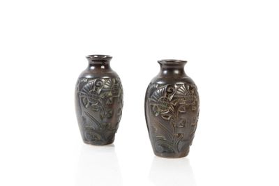 two brown vases sitting next to each other on a white surface