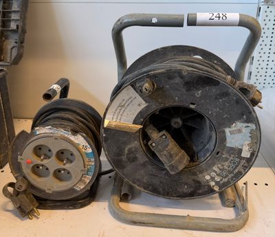 two old reels sitting on a table next to each other