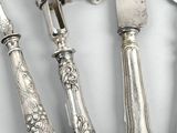 five silverwares and a knife on a table