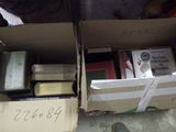 a box of books sitting on the floor next to a box of books
