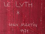 a close up of a red wall with writing on it
