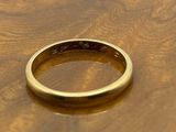 a gold ring sitting on top of a wooden table