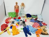 beaucoup de vêtements par terre et une poupée dans une boîte