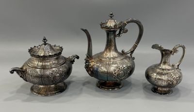 two silver teapots and a coffee pot on a table