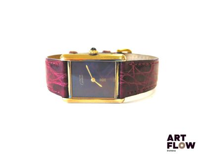 an image of a wrist watch with a purple dial and a gold band
