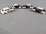 four toy cars that are lined up on a table