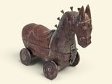 un cheval en bois qui est posé sur une surface blanche
