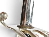 a close up of a silver and gold sword on a white background
