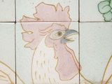 a tile with a rooster on it on the wall