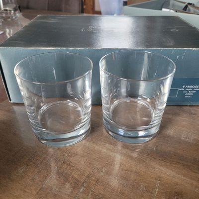 two glasses sitting on a table next to a box of wine glasses