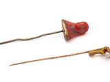 pair of red and gold hair pins and a gold and pearl hair pin