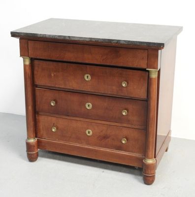 une petite commode en bois avec un plateau en marbre