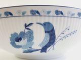 a blue and white bowl with a bird design on it