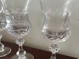 three wine glasses sitting on a table next to each other