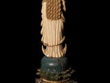 an antique statue of a woman with long hair sitting on top of a pedestal