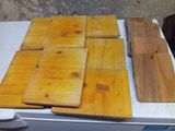 several pieces of wood are laying on top of a refrigerator