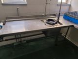 a stainless steel sink in a kitchen with a window
