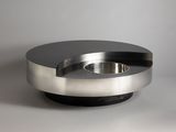 a metal bowl with a black top on a table