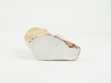 a small piece of white marble on a white surface