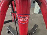 un gros plan d'un vélo rouge sur lequel est collé un autocollant