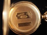 a close up of a gold pocket watch on display