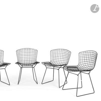 three black wire chairs sitting next to each other on a white surface