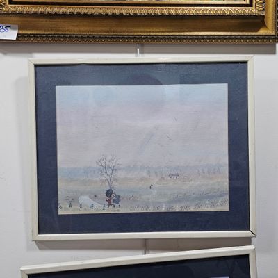two framed pictures on the wall of a room