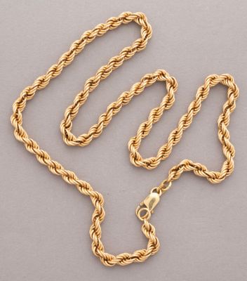a gold rope necklace with a clasp on a gray background
