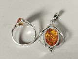 sterling silver and amber earrings with orange stones on a white surface
