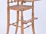 a wooden high chair with a tray on top of it