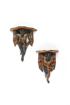 two wall sconces that are made of wood and decorated with animals