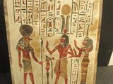 an egyptian painted plaque depicting a group of egyptian men and women