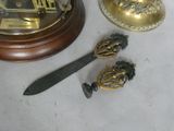 a small knife and a gold plate on a table