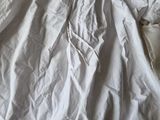a white dress that is laying on a bed