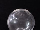 a clear glass vase on a black surface