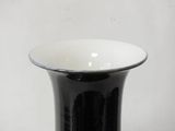 a black and white vase sitting on a table