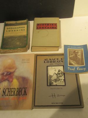 several books on a table with pictures of people on them