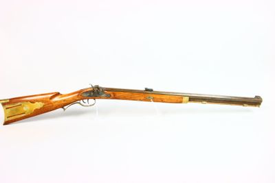 an old rifle with a wooden barrel on a white background