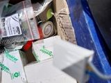 a cardboard box filled with assorted items on the ground