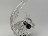 a glass sculpture of a fish on a black base