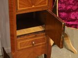 a small wooden cabinet with a drawer on top of it