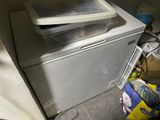 a white washer and dryer sitting next to each other in a room
