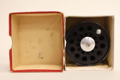 a small box with a small black object inside of it