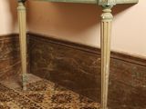 a marble top table with a mirror on top of it