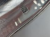 an antique silver plate with a black and white design on it
