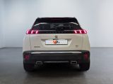 the rear end of a white suv parked in a room
