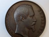 an old coin with a man ' s face on it sitting on a table
