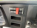 a close up of a dashboard of a car with a red button