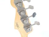 a close up of a guitar neck with a guitar tuner