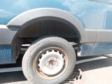 a blue truck that has a flat tire on it